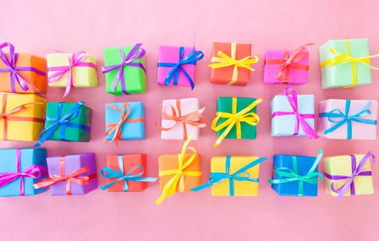 Small gifts wrapped in colorful paper with small ribbons