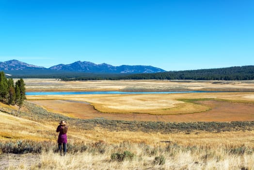 Young woman looking out over a valley in Yellowstone National Park