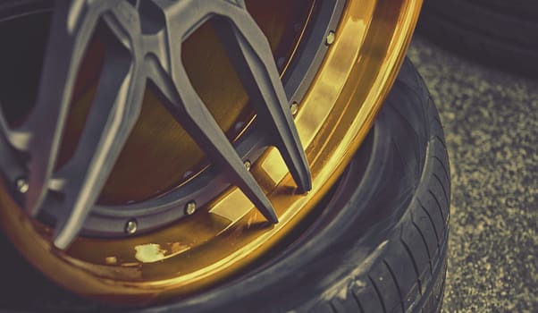 closeup detail of gold aluminum car wheel