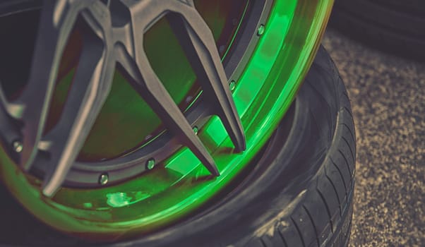 closeup detail of green aluminum car wheel