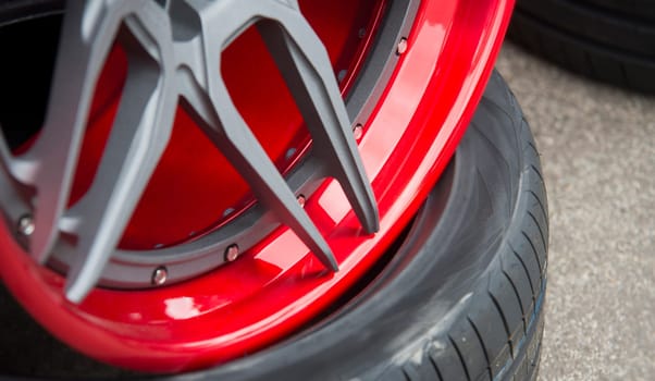closeup detail of red aluminum car wheel