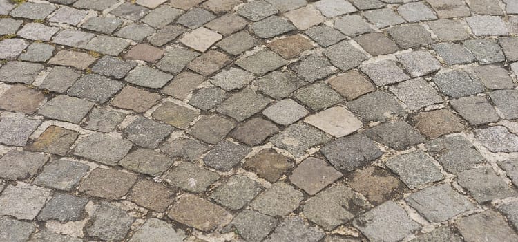 Panorama old  traditional european style cobblestone road texture background with granite blocks, stones and brickwork pattern