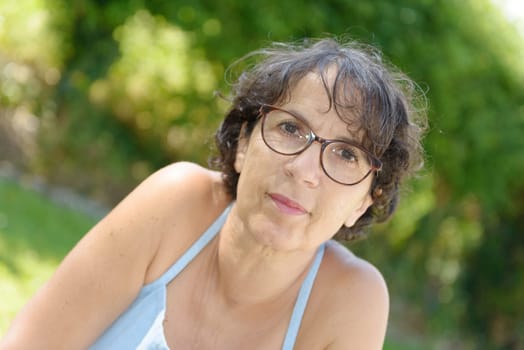 a portrait of a mature woman with glasses