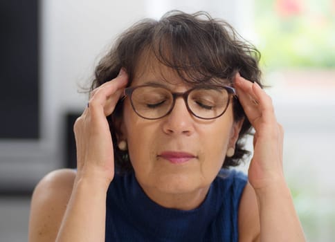 beautiful mature woman with a headache