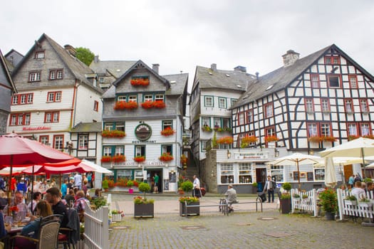 MONSCHAU, GERMANY - JULY 30, 2016: small town Monschau with unidentified people. The historic town center has many half-timbered houses and narrow streets remained nearly unchanged for 300 years