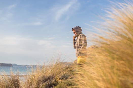 Sporty active man looking at distance, enjoying beautiful nature, freedom and life at serene landscape at Balos beach. Active lifestyle outdoors.