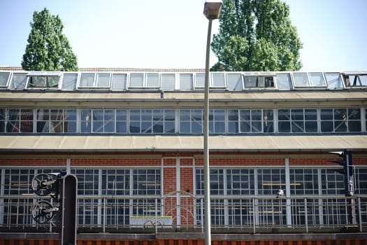 An S-Bahn stop in Berlin with skylights and adjacent rail and bridge.