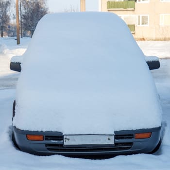 car fully covered with a fresh snow