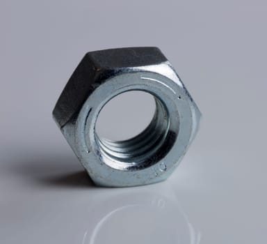 Hardware Nut Close Up on gray background.