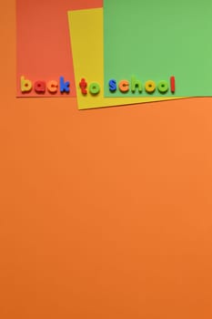 The words BACK TO SCHOOL with magnetic letters on colorful paperboard