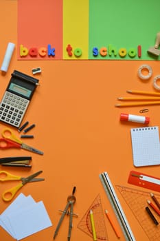 School supplies on colorful paperboard and the words BACK TO SCHOOL