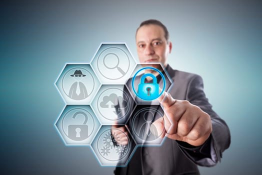 Business man in gray suit locking a virtual padlock for fraud prevention. Business concept for protection from data theft, electronic deception, civil and criminal offense perpetrated via internet.