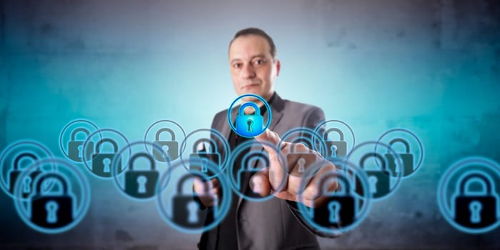 Business manager with positive face is picking one virtual lock icon among a crowd of multiples. Information technology concept for virtualization, data privacy, and information security management.