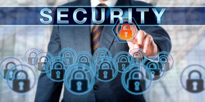 Corporate executive is pushing SECURITY on a touch screen interface. Business metaphor and information technology concept for computer security, crime prevention and law enforcement.