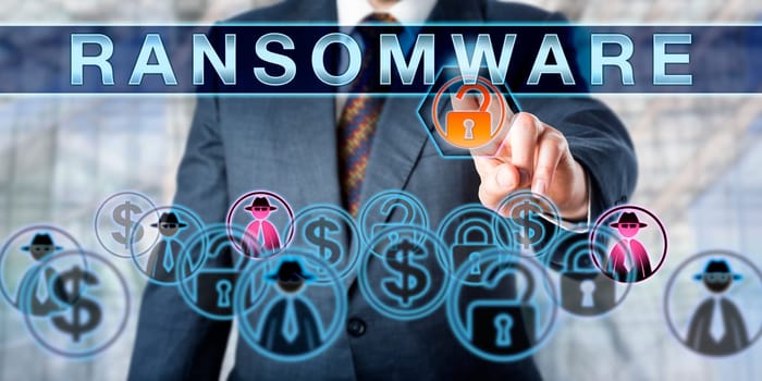 Corporate manager is touching RANSOMWARE on an interactive control screen. Information security concept for the crime of extorting ransom money via computer malware causing a access restrictions.