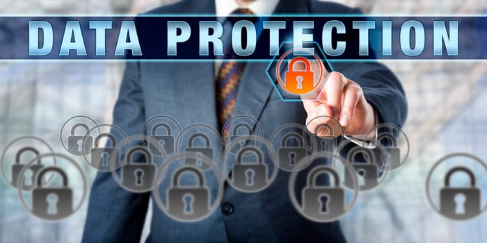 Businessman is pressing DATA PROTECTION on an interactive control screen. Business metaphor. Information technology concept for practices, regulations and policies designed to protect sensitive data.