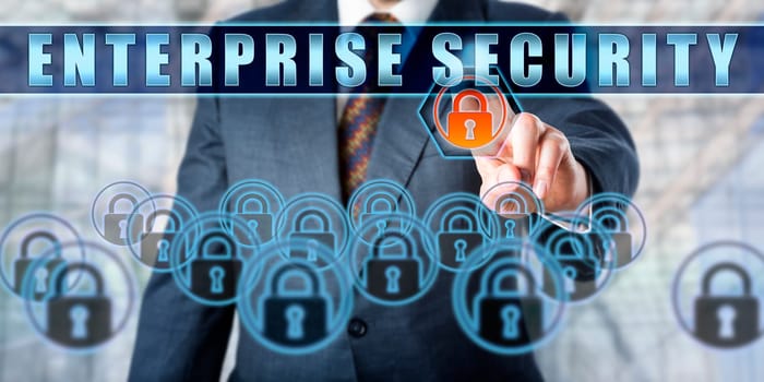 Business executive is pressing ENTERPRISE SECURITY on an interactive control screen. Business security practice metaphor. Concept involving computer security and enterprise architecture.