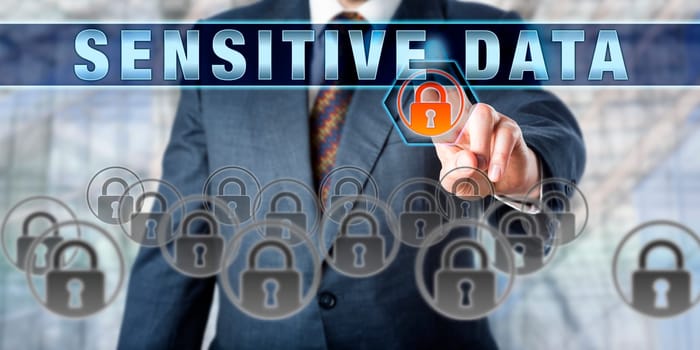 Corporate manager is pressing SENSITIVE DATA on an interactive touch screen. Information technology and computer security concept for safe and secure digital storage of mission critical data files.