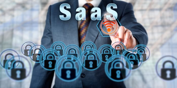 Manager pressing SaaS on an interactive touch screen interface. Business services delivery metaphor. Information technology concept for Software as a Service and service-oriented business computing.