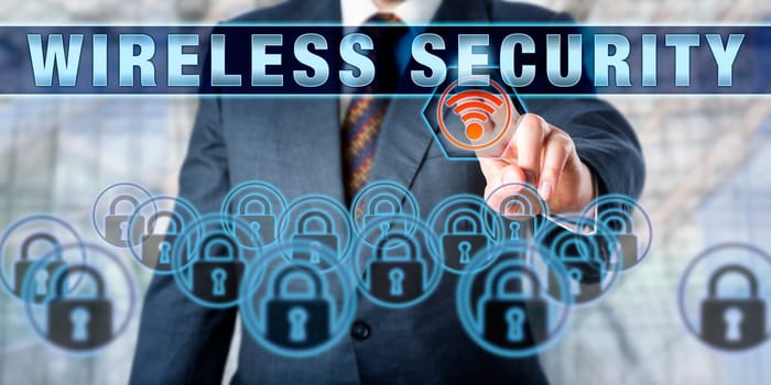 Business executive touching WIRELESS SECURITY on an interactive screen. Information technology concept involving computer network security, wireless networking and prevention of unauthorized access.