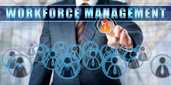 Enterprise manager is pushing WORKFORCE MANAGEMENT on an interactive touch screen. Business concept involving human resource management, business software and technology.