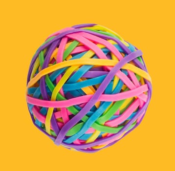 Rubber elastic band ball on light yellow background