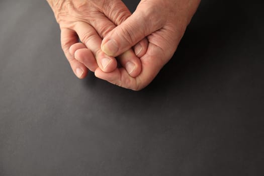 Man’s hands on black background with copy space