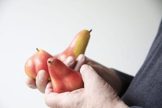 Profile view of man holding pears in his hands with copy space