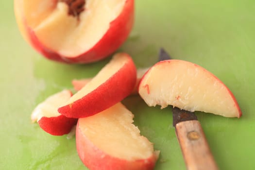 Cutting up a fresh, juicy peach into slices with a paring knife