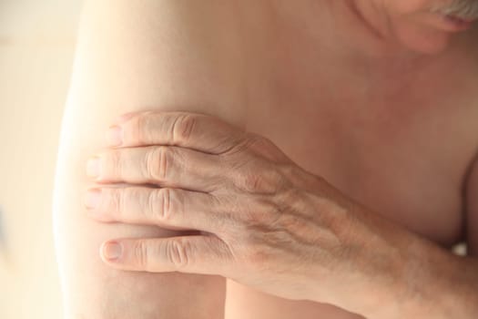 A man experiences soreness in his upper arm.