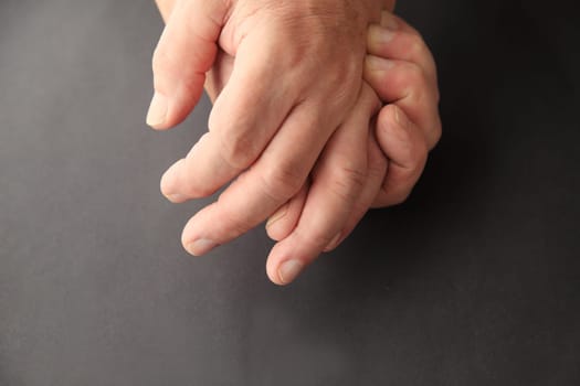 Senior man holding his painful hand