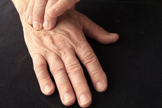 Senior man with pain on the back of his hand, copy space included