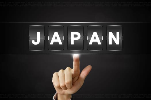 business hand pushing JAPAN on Flipboard Display