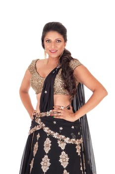 A gorgeous young woman standing in a gold color top and black skirt.halve length isolated for white background..
