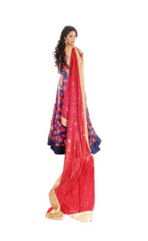 A lovely woman standing in a blue dress and long black hair holding.a long red vail, isolated for white background..