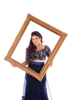 A beautiful woman in a dark blue skirt and blouse holding a picture frame.in front of her, isolated for white background..