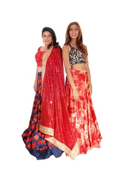 Two beautiful young woman standing in gorgeous colorful dresses.isolated for white background..