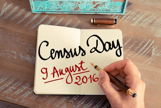 Retro effect and toned image of a woman hand writing a note with a fountain pen on a notebook. Handwritten text Census Day 9 August 2016, Australia as concept image
