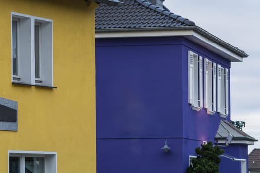 Forder view of two house fronts with fresh wall paint..
