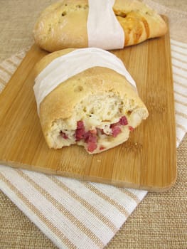 Hand bread street foodwith ham cubes and cheese