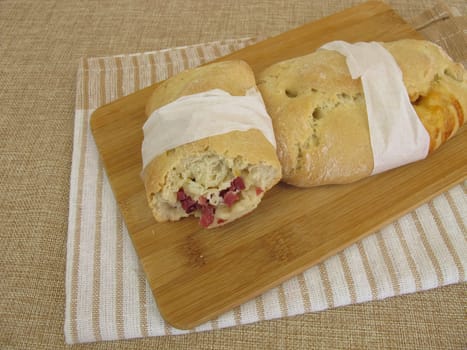 Hand bread street foodwith ham cubes and cheese