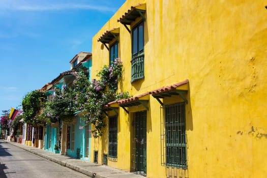 Colorful street with colonial architecture and a Colombian flag in Cartagena, Colombia