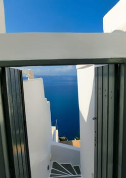 View to the sea from stairs in Oia the most beautiful village of Santorini island in Greece
