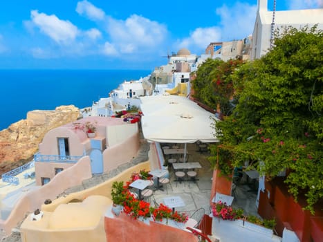 Oia, Greece - June 10, 2015: Santorini - The restaurant geared to romantic diner in Oia and the sea in the background. Beautiful terrace with sea view on Santorini island, Oia, Greece.