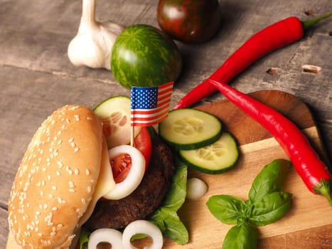 Ingredients of a homemade burger on a rustic wooden ktichen table