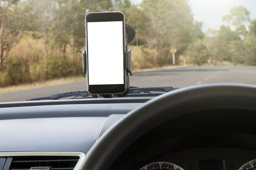 phone and mounted holder in car on rural road