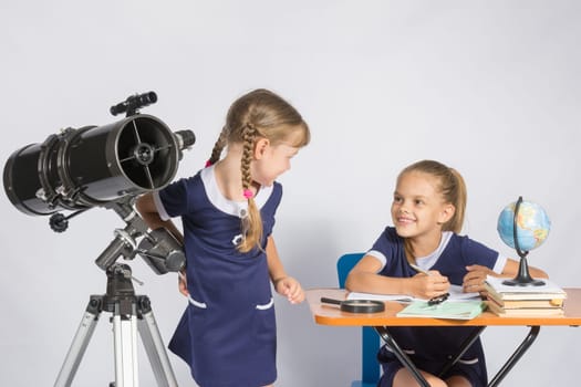 The two girls looked at each other in the classroom Astronomy
