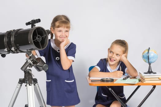 Girl mysteriously astronomer looks into the distance, a classmate with a smile looked at her