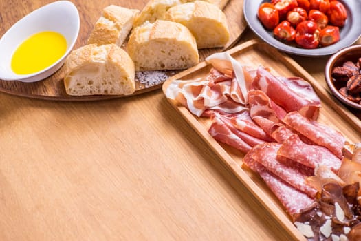 Tapas food, served in small bowls cold meat, goat cheese. A meal for sharing