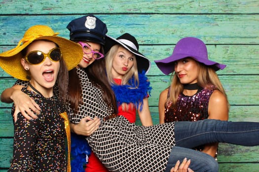 4 fine ladies with hats in front of a photo box
